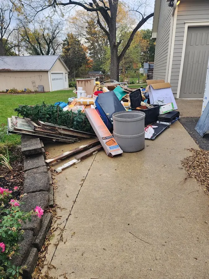Dumpster being loaded with debris for 12 Yard Dumpster Rental in Lima